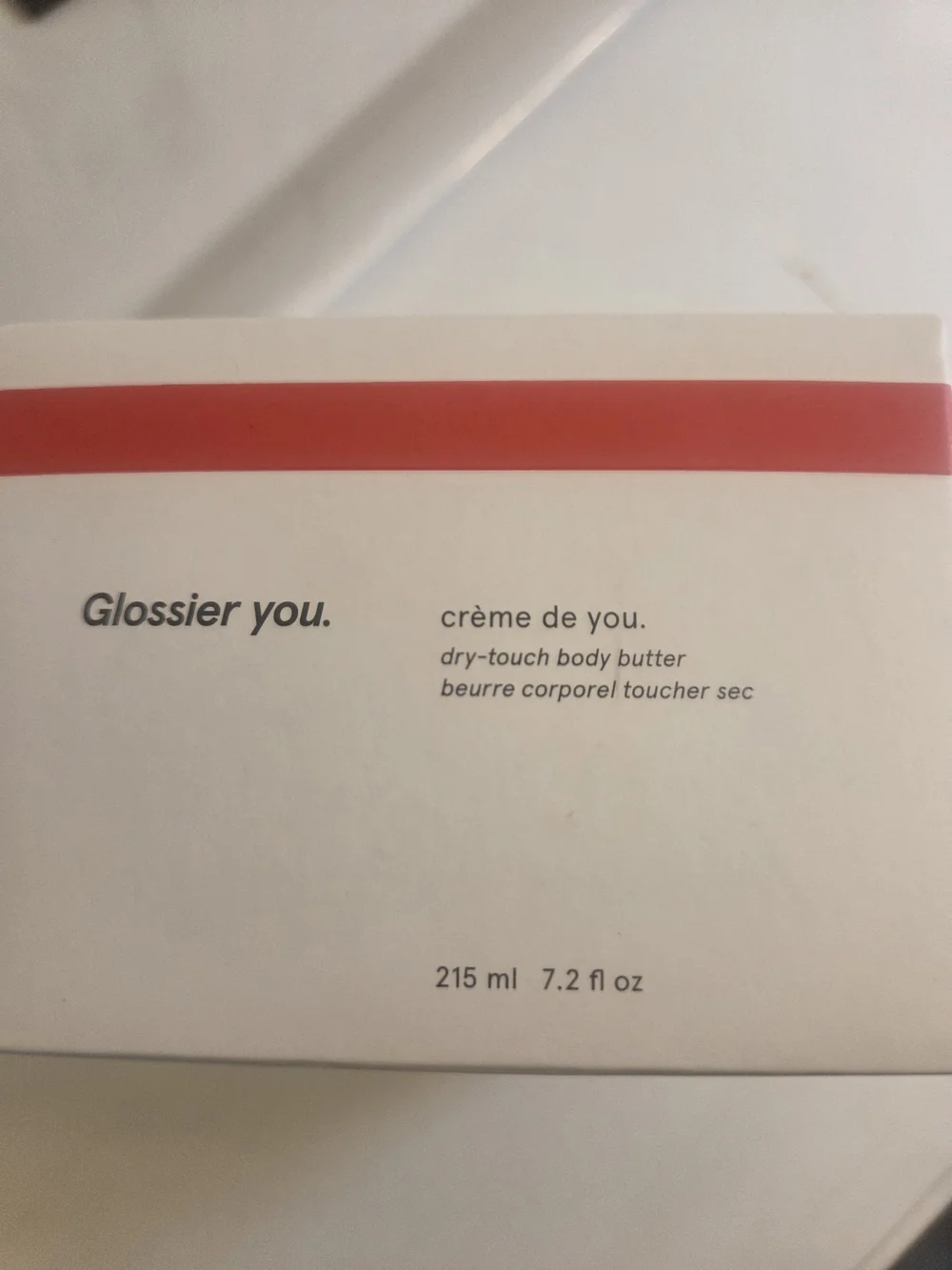 Glossier cream white with red stripe